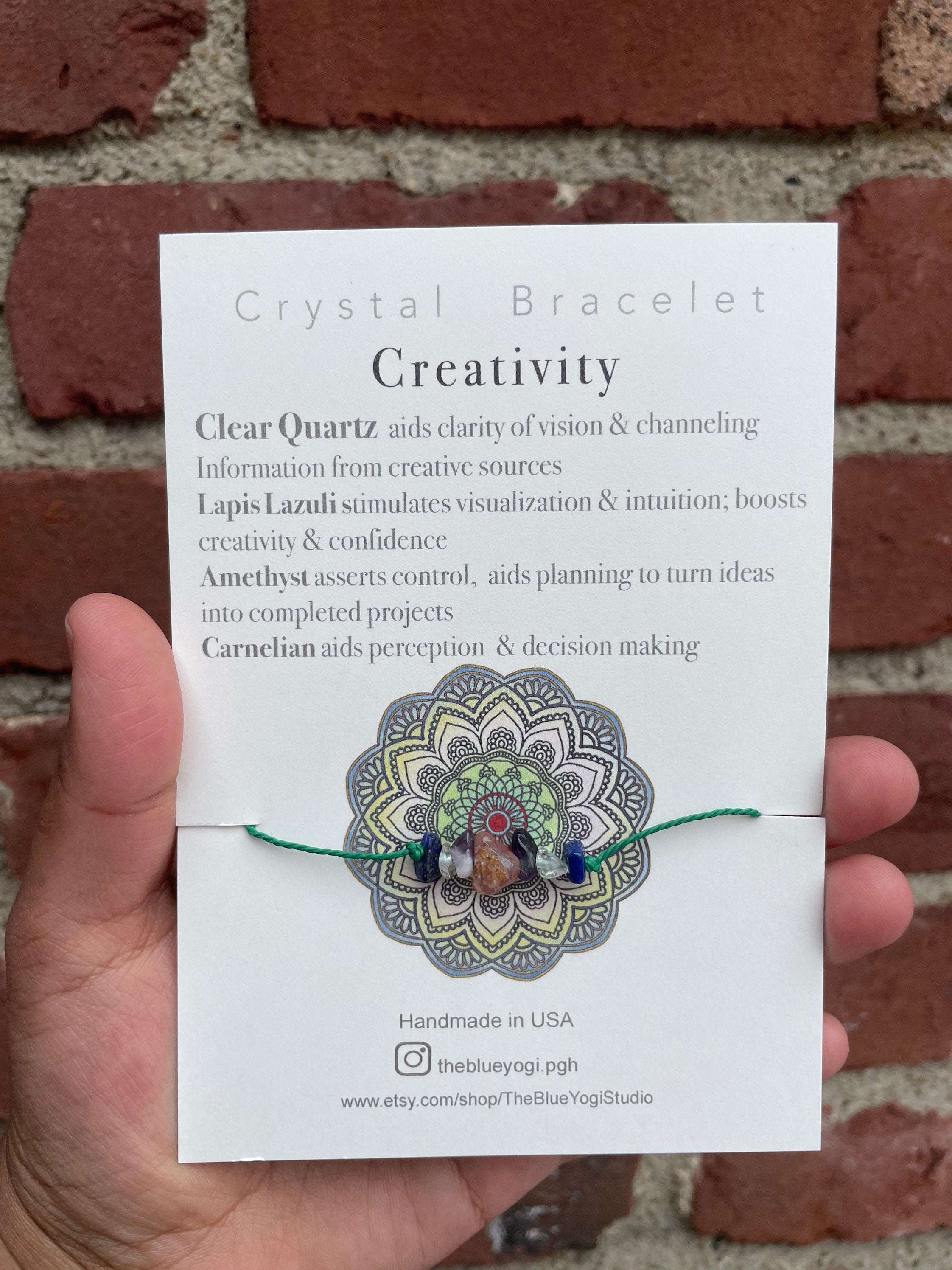 A handcrafted Creativity Bracelet featuring natural gemstones with a tie closure, displayed alongside a watercolor Mandala art card.