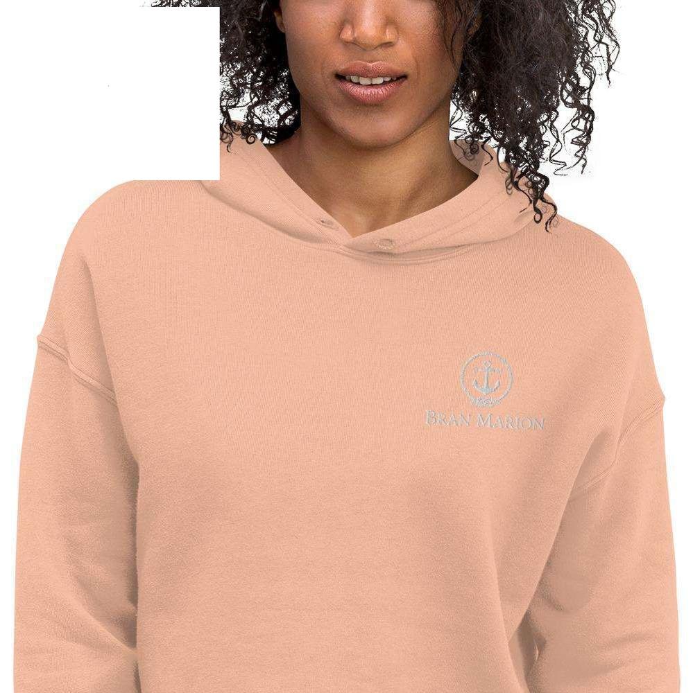 A stylish cropped hoodie featuring a raw hem and matching drawstrings, perfect for casual wear.