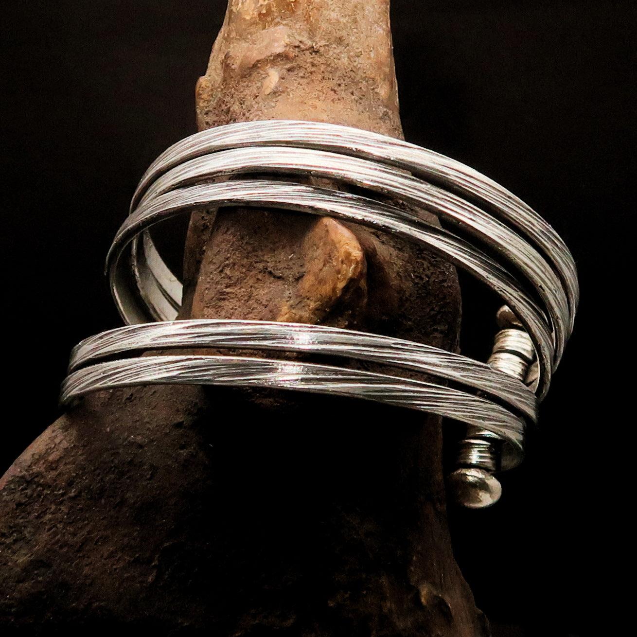 A beautifully handcrafted minimalistic 5 String Sterling Silver Bracelet showcasing its flexible design and hallmark 925.