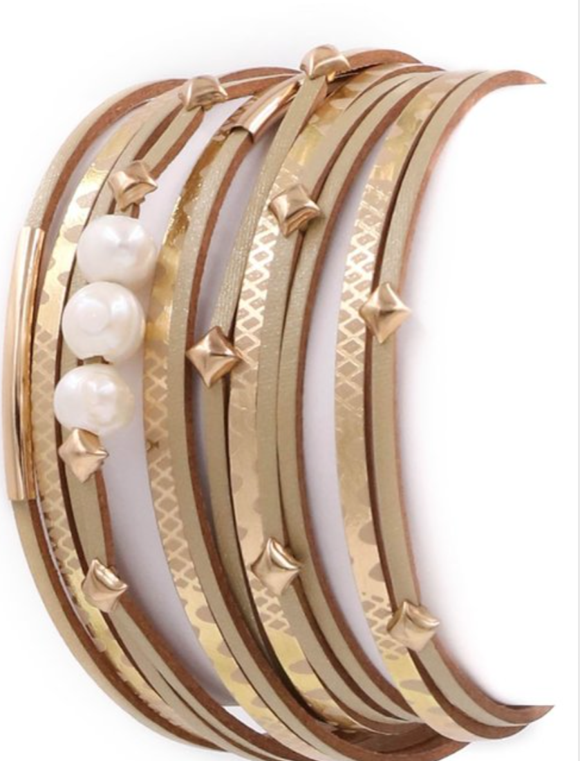 A stylish faux leather bracelet featuring three elegant pearls in a layered design, showcasing a trendy and modern look.