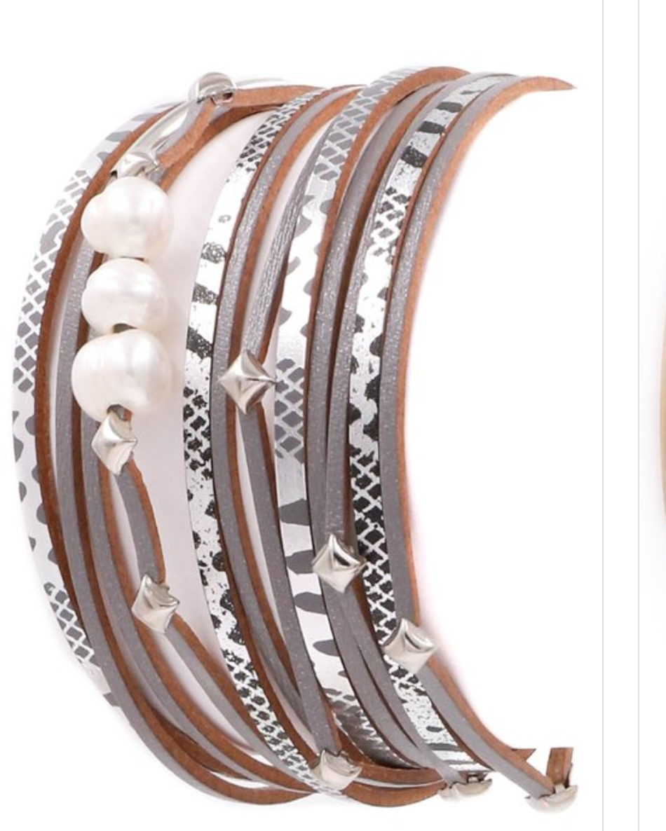 A stylish faux leather bracelet featuring three elegant pearls in a layered design, showcasing a trendy and modern look.