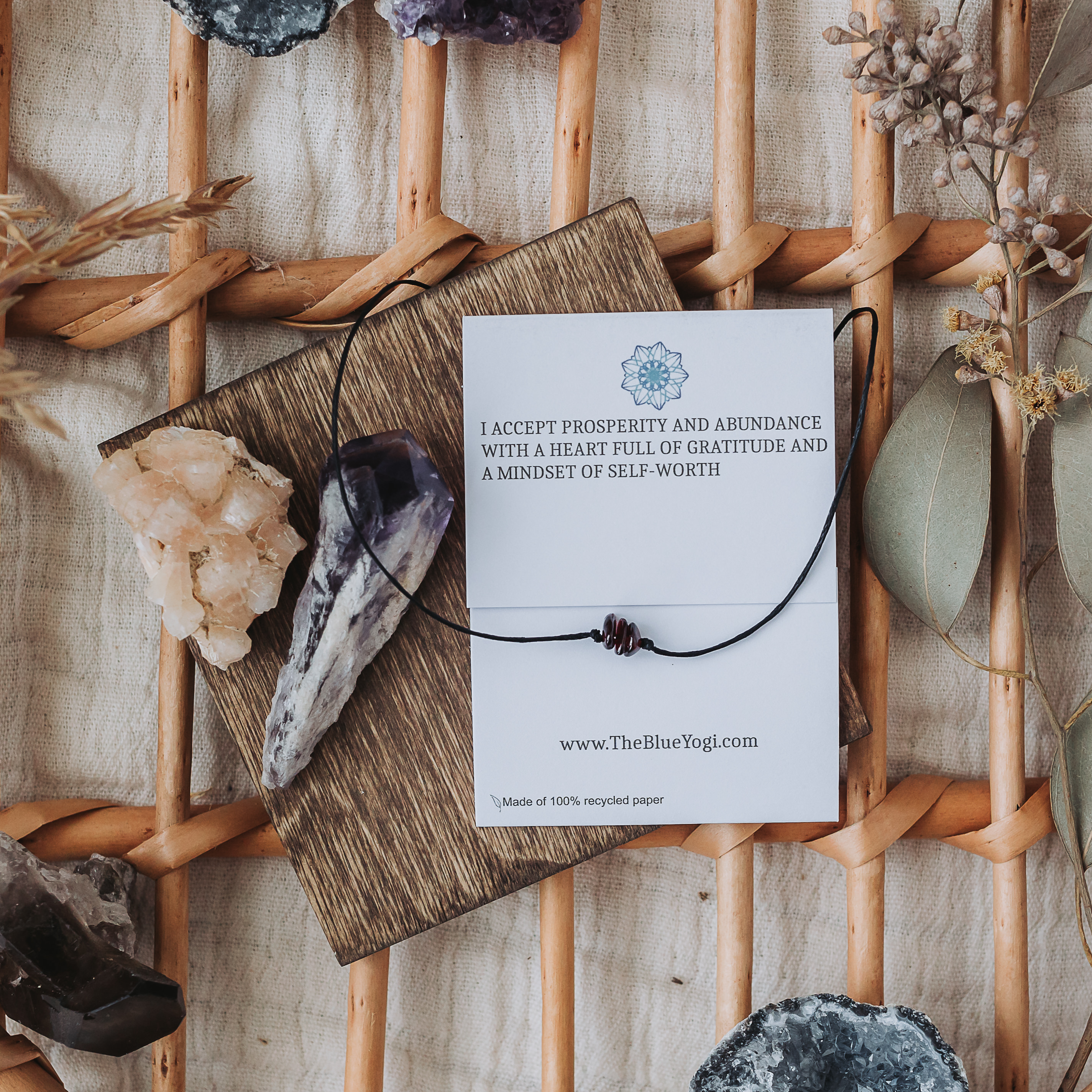 A Garnet Healing Band featuring natural garnet gemstones and a tie closure, displayed with a watercolor Mandala art card.