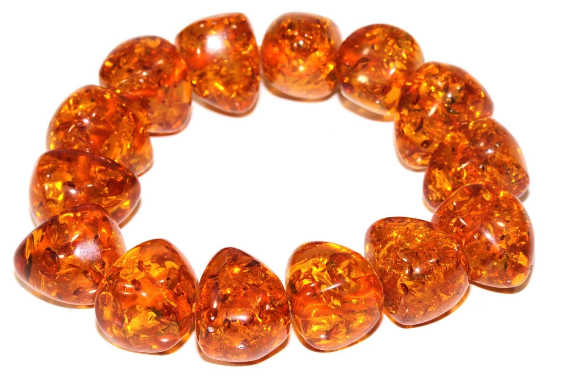 Glowing Baltic Style Amber Bracelet featuring large chunky and rounded faux amber beads on an elastic band, showcasing a shimmering fire orange color.