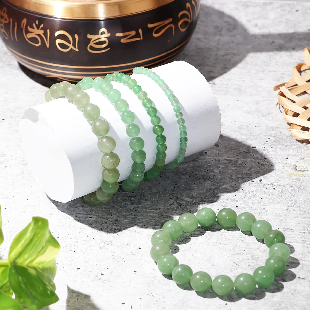 A close-up view of a Green Aventurine Round Beads Bracelet showcasing its natural green stones and elastic design.