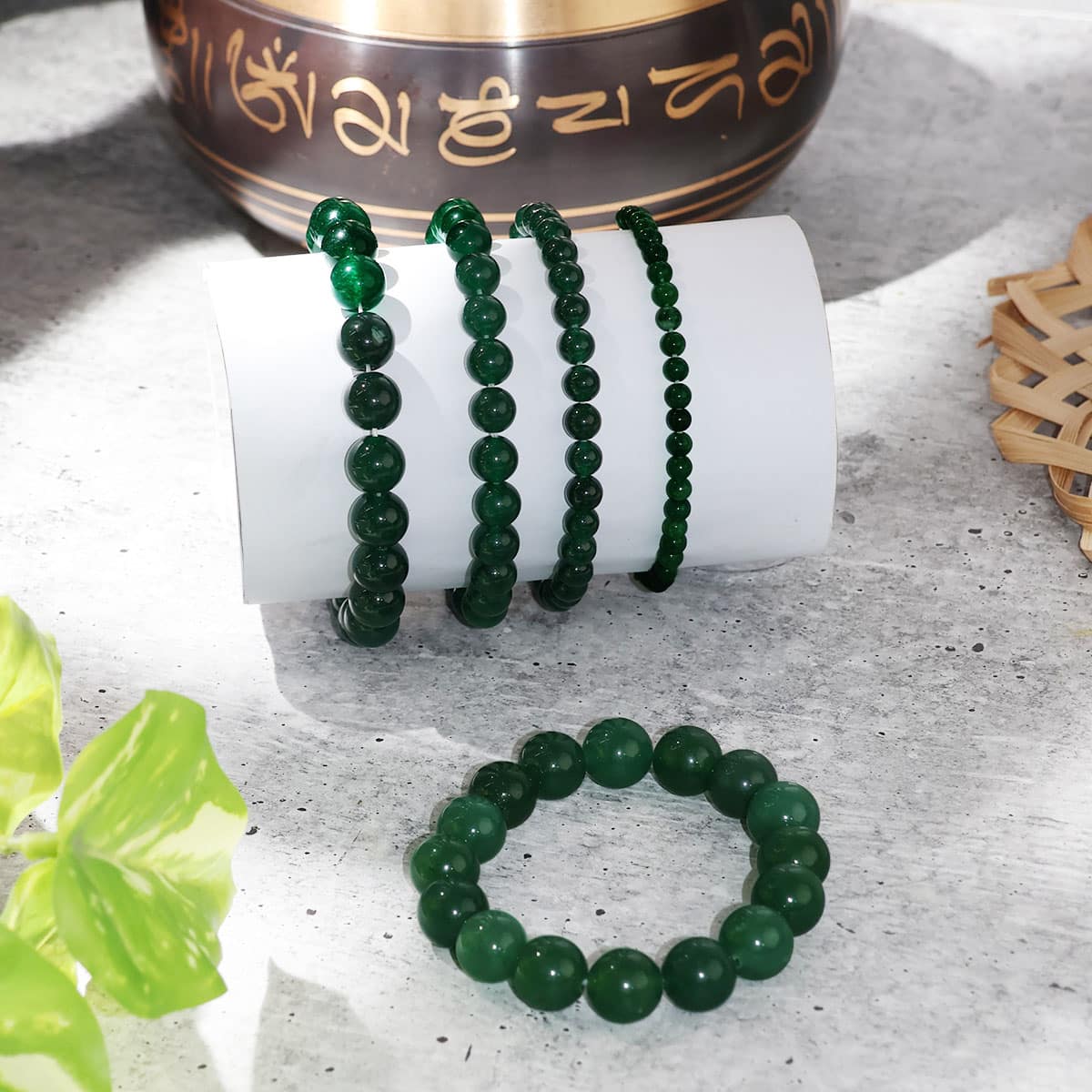 A beautiful Green Jade Round Beads Bracelet showcasing natural jade beads in various sizes, elegantly strung on an elastic band.