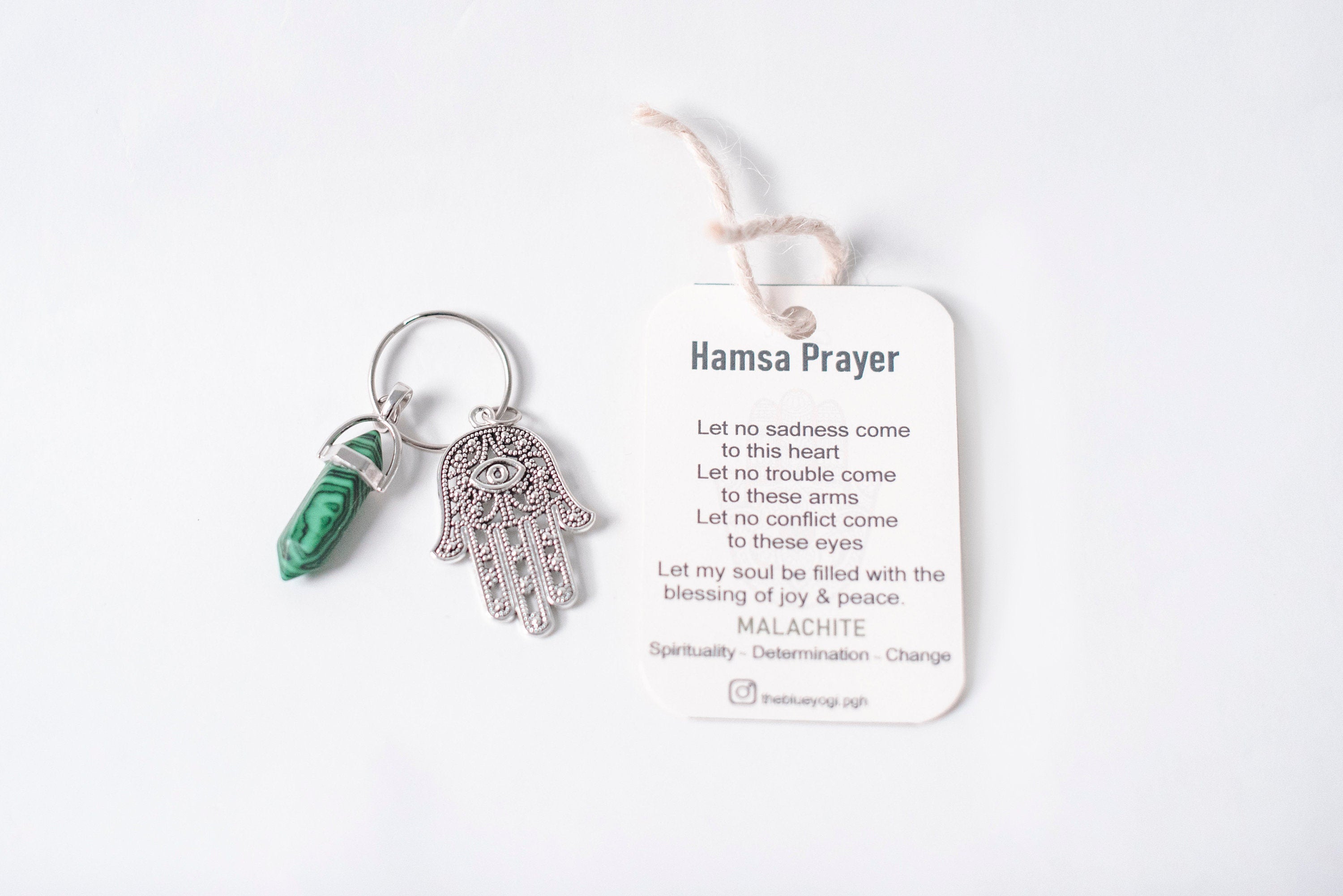 A beautifully crafted Hamsa & Malachite Key Chain featuring a hexagonal malachite stone and a protective Hamsa charm.