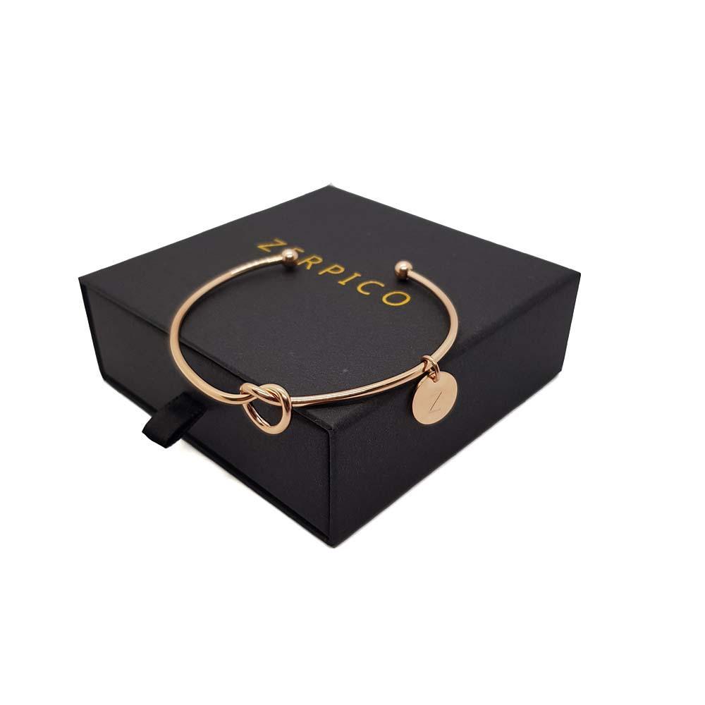 Elegant Knot Bangle featuring an infinity symbol, crafted from rose gold plated Zinc Alloy, perfect for stacking with other bracelets.