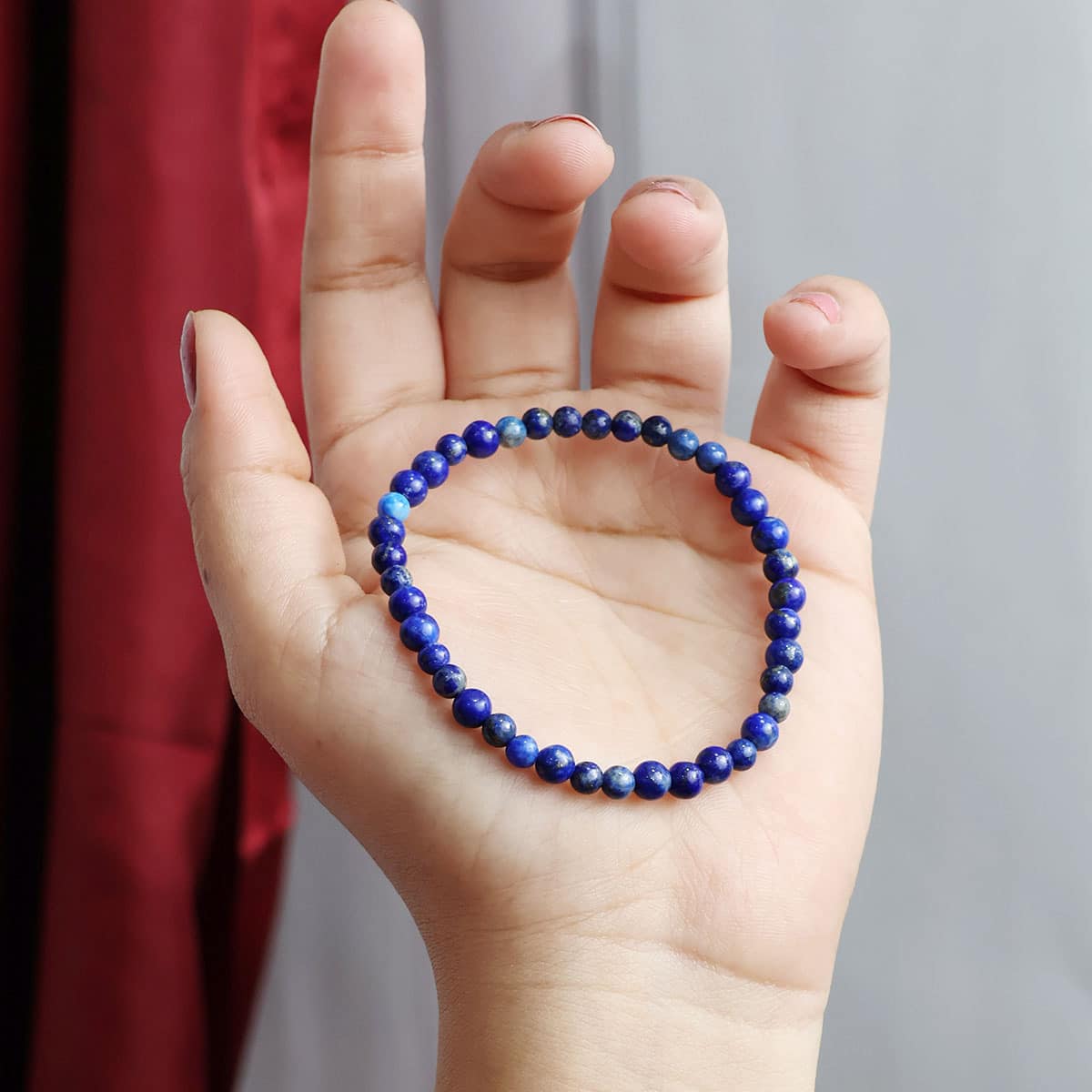 Lapis Lazuli Round Beads Bracelet showcasing deep blue beads with gold flecks, elegantly strung on elastic for a comfortable fit.