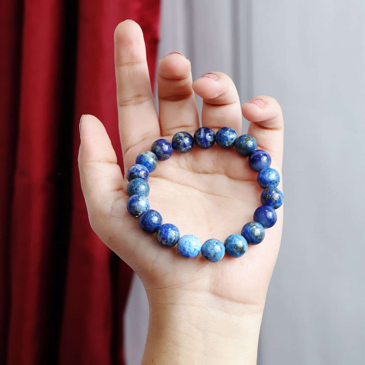 Lapis Lazuli Round Beads Bracelet showcasing deep blue beads with gold flecks, elegantly strung on elastic for a comfortable fit.