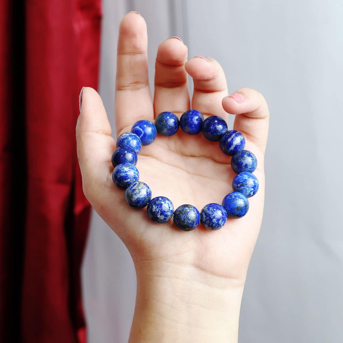 Lapis Lazuli Round Beads Bracelet showcasing deep blue beads with gold flecks, elegantly strung on elastic for a comfortable fit.