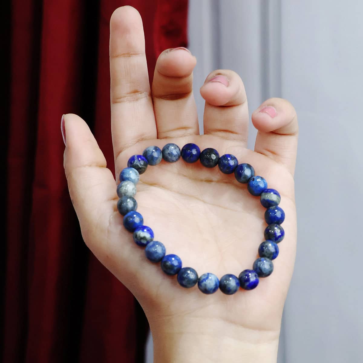 Lapis Lazuli Round Beads Bracelet showcasing deep blue beads with gold flecks, elegantly strung on elastic for a comfortable fit.