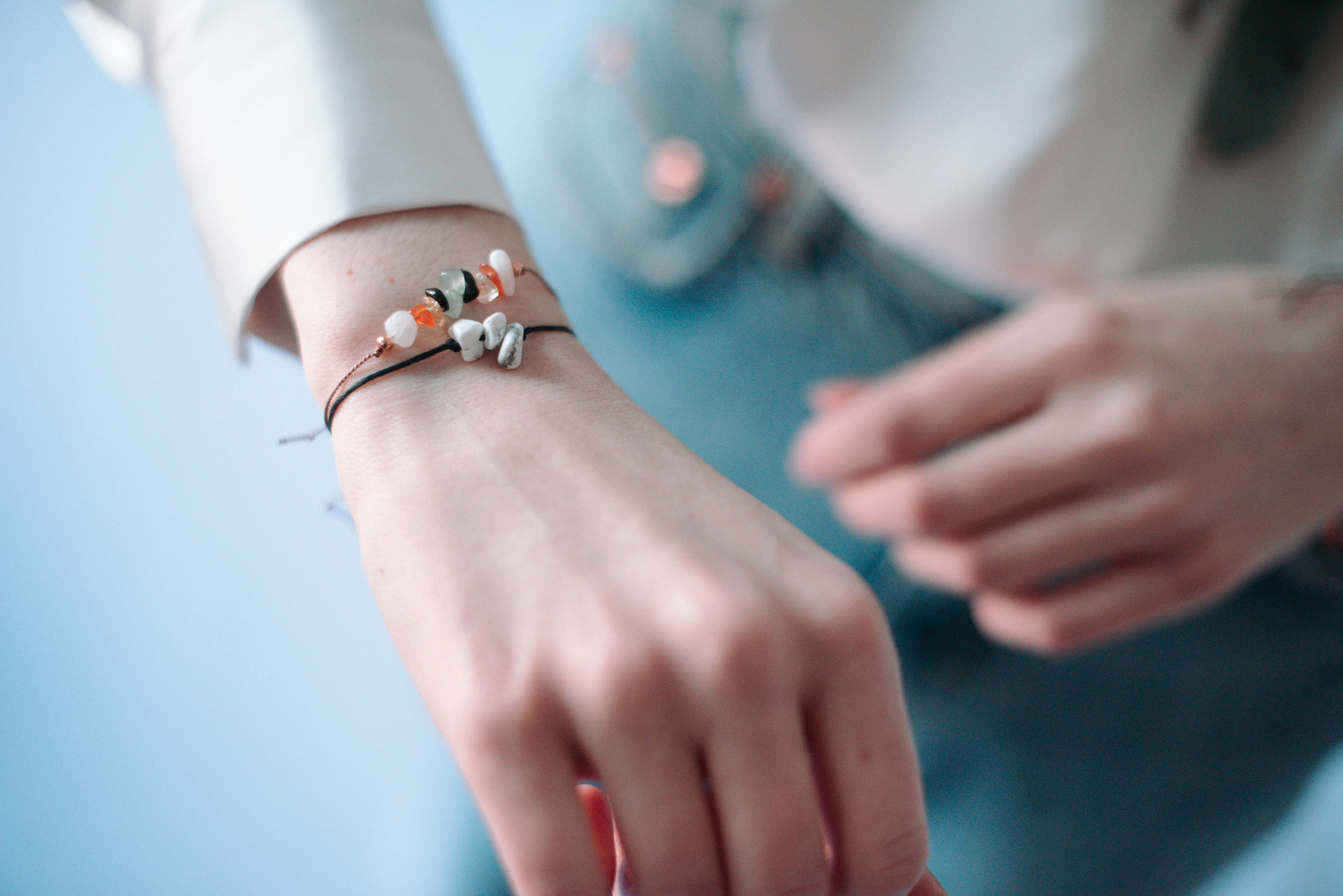 A beautiful boho-style manifestation crystal bracelet featuring natural gemstones with a tie closure, displayed with a watercolor Mandala art card.