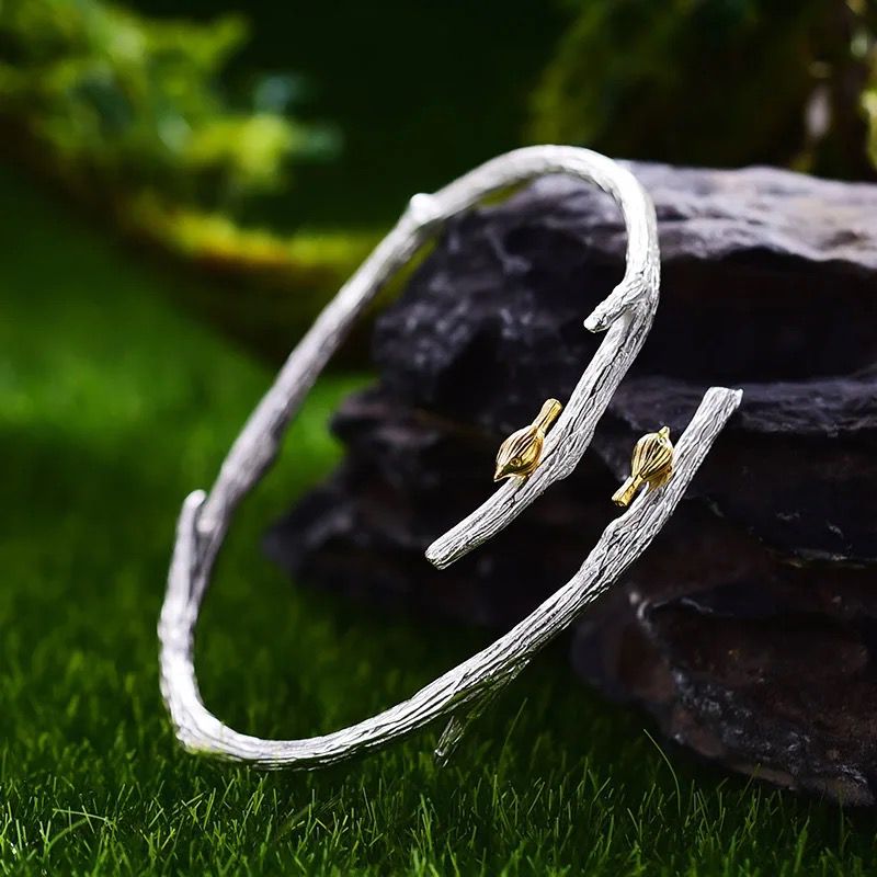 A beautiful silver bracelet featuring an 18K gold-plated butterfly, showcasing intricate detailing and nature-inspired design.