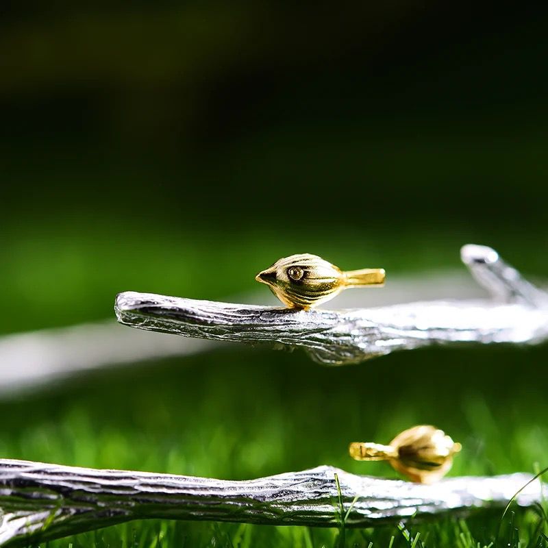 A beautiful silver bracelet featuring an 18K gold-plated butterfly, showcasing intricate detailing and nature-inspired design.