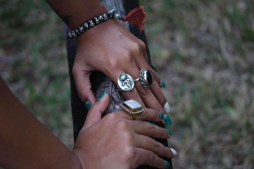 Om Bone Mala Yoga Bracelet featuring black and white colors with a Sanskrit OM pattern and a decorative brown tassel.