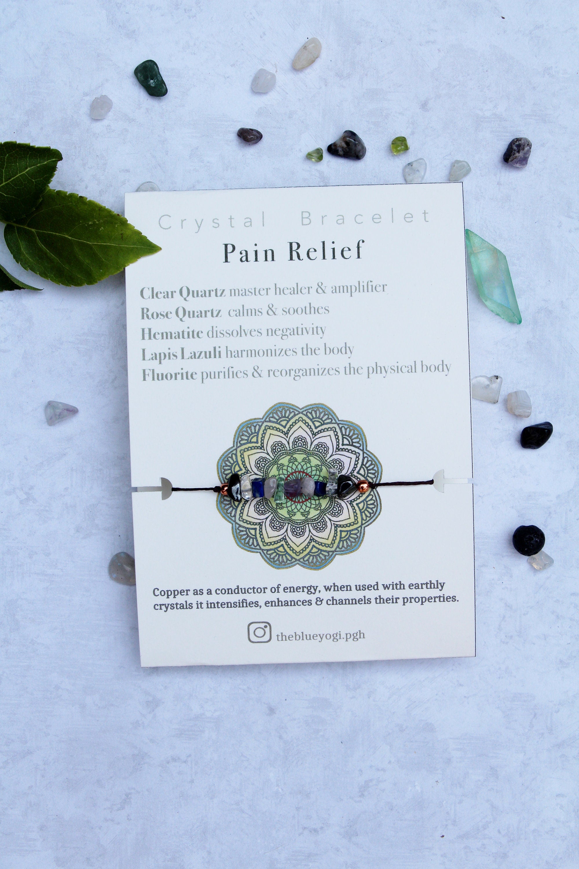 Eco-friendly Pain Relief crystal bracelet anklet made of natural gemstones with a tie closure, showcasing unique crystals and a watercolor Mandala card.