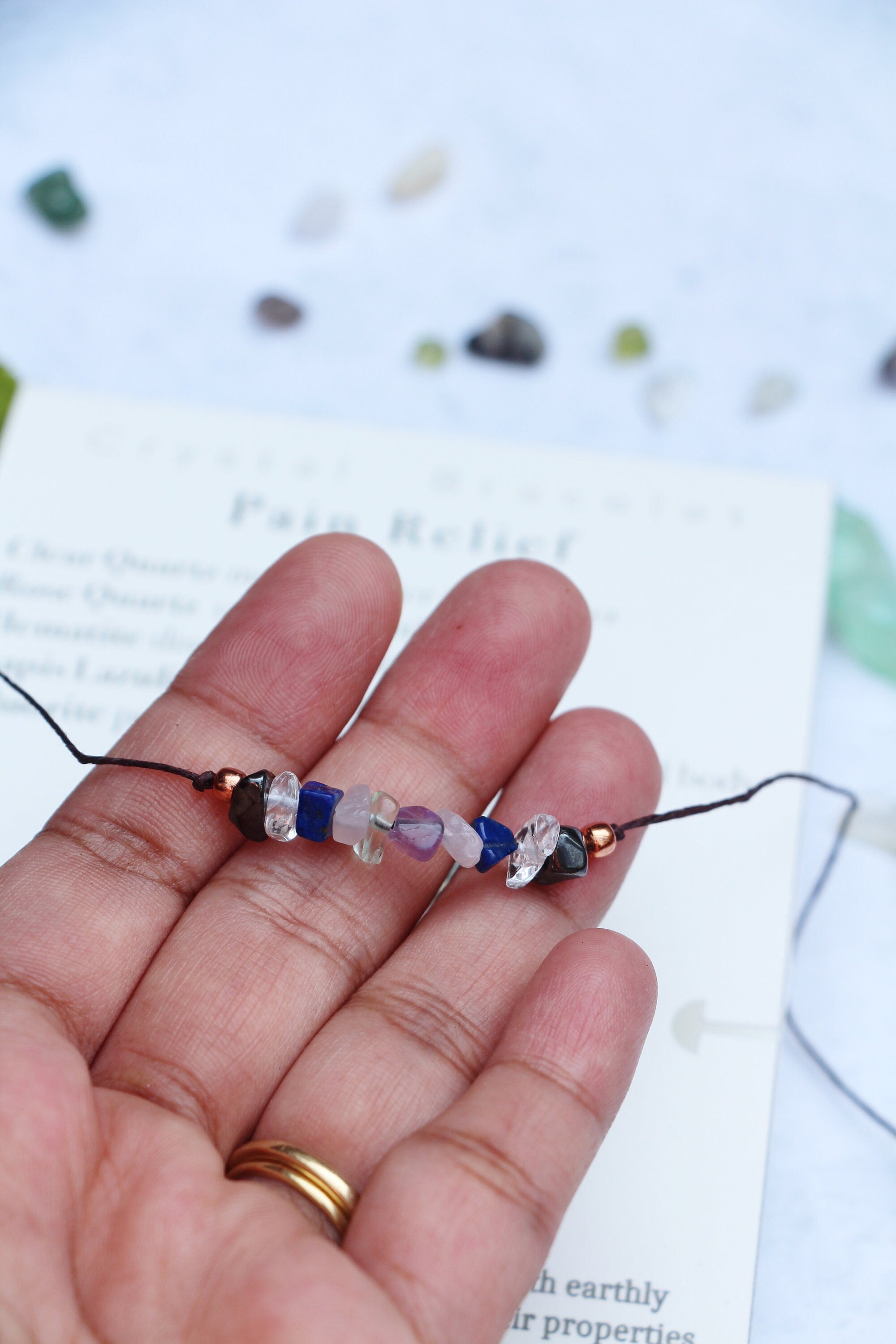 Eco-friendly Pain Relief crystal bracelet anklet made of natural gemstones with a tie closure, showcasing unique crystals and a watercolor Mandala card.