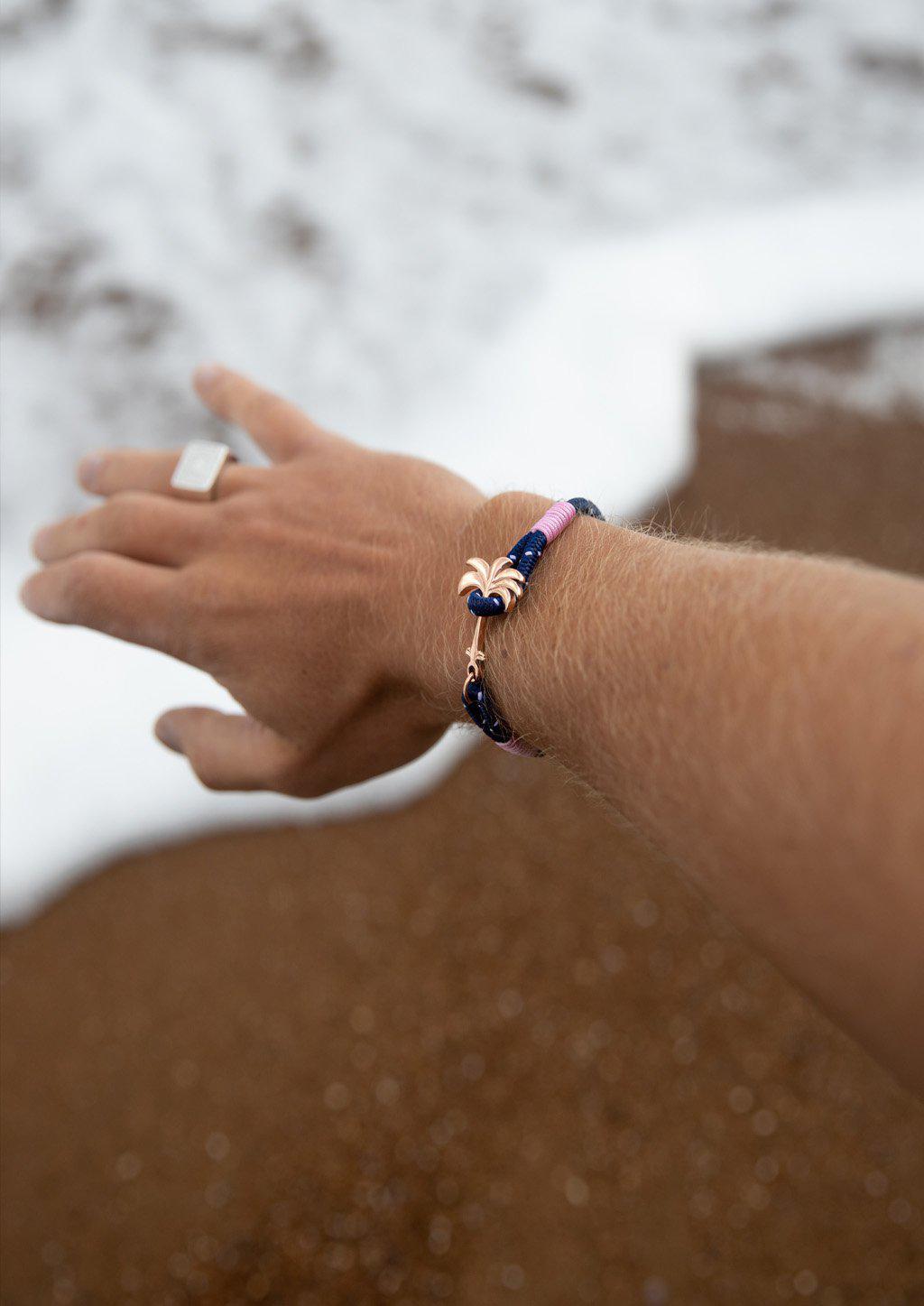 Daybreak Palm Band bracelet featuring a blue and pink nylon design with a unique rose palm tree anchor.