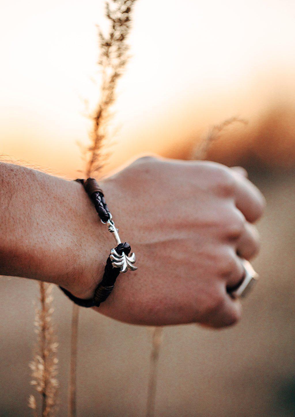 Oakland Palm Band featuring a brown leather strap and silver palm tree anchor, symbolizing happiness and tranquility.