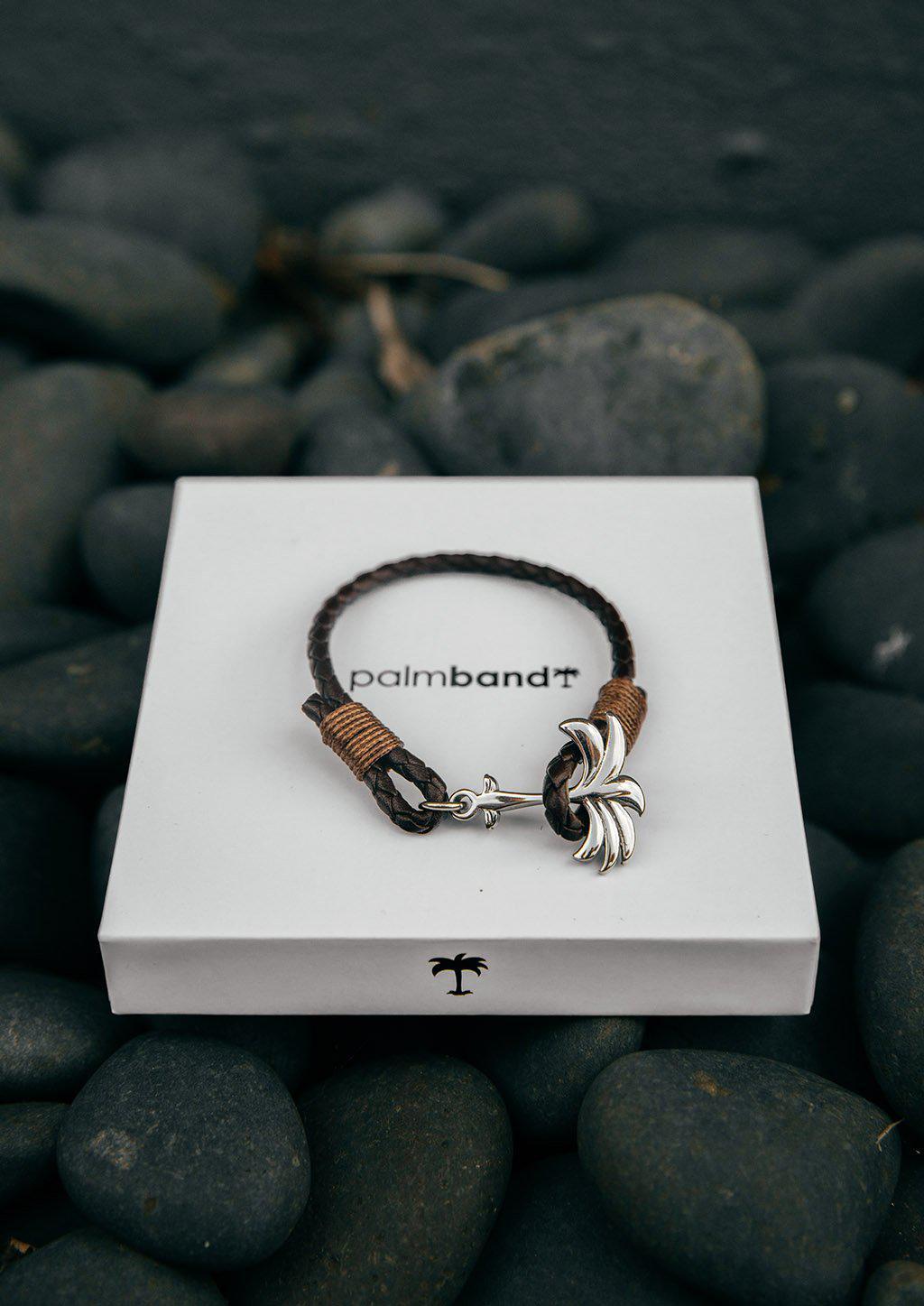 Oakland Palm Band featuring a brown leather strap and silver palm tree anchor, symbolizing happiness and tranquility.