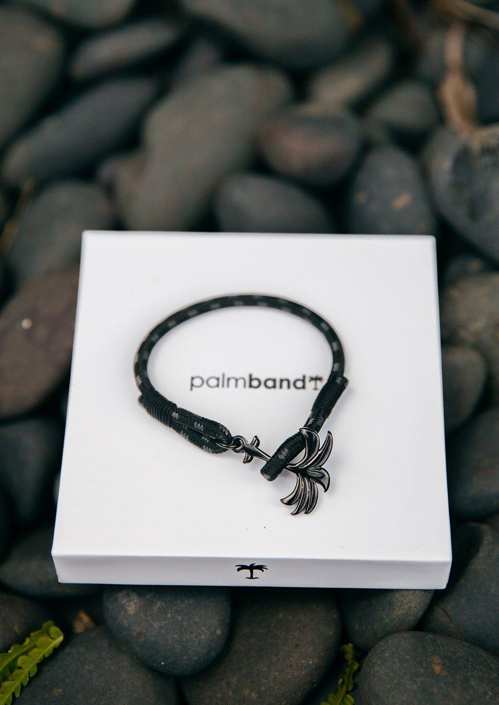 Palmband - Phantom Black bracelet featuring a black palm tree anchor on a black and gray nylon band, symbolizing happiness and tranquility.