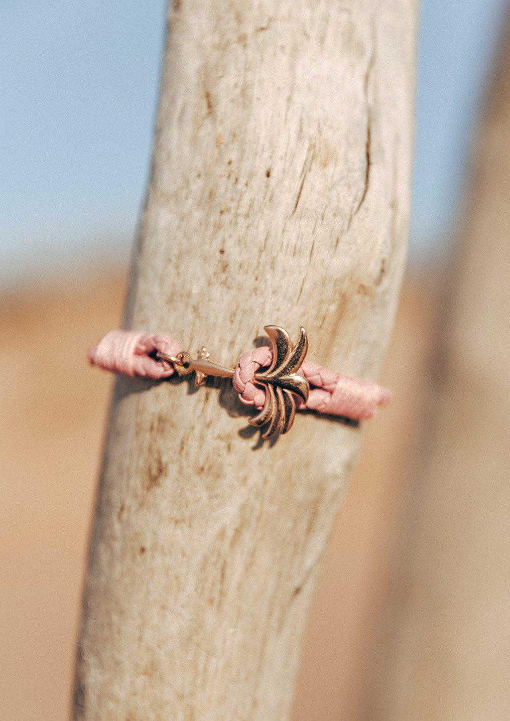 Rosette Palm Band featuring a pink leather strap and rose gold palm anchor, symbolizing happiness and tranquility.