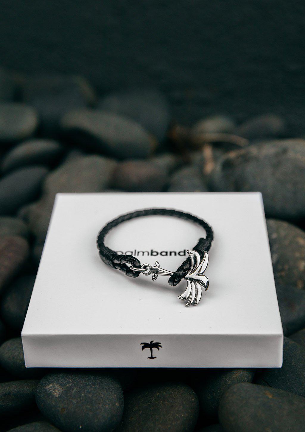 Palmband - Starlight featuring a braided black leather band and a unique palm tree anchor design.