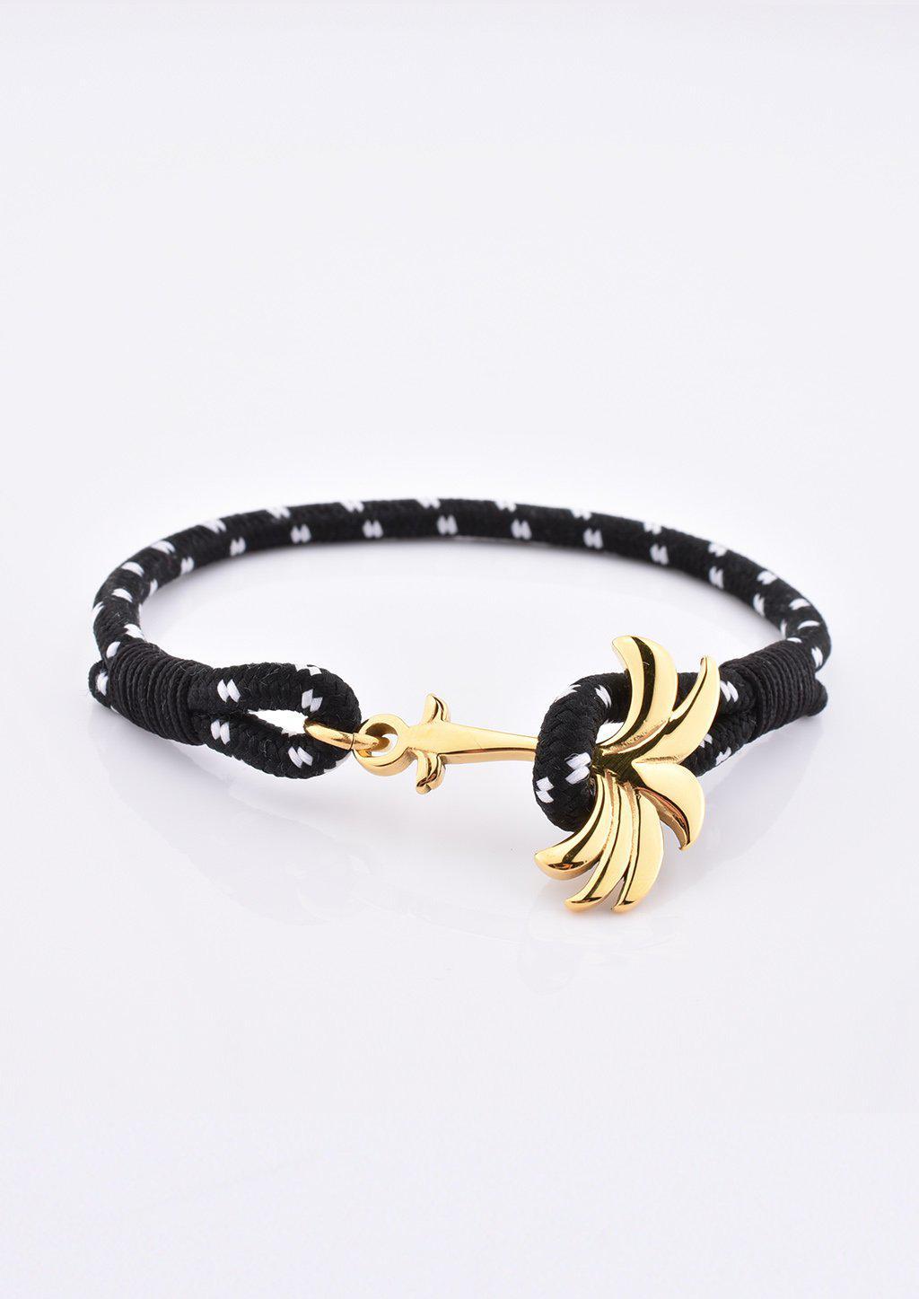 Trophy Palm Band featuring a gold palm tree anchor on a black and white nylon rope, symbolizing positivity and success.