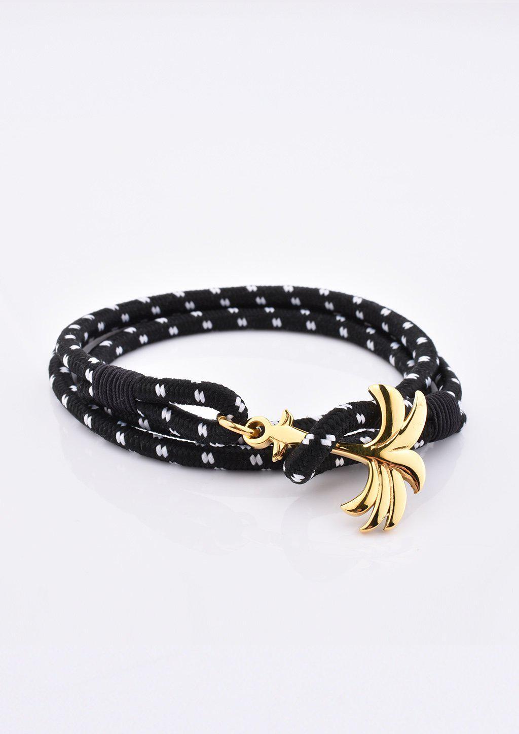 Trophy Palm Band featuring a gold palm tree anchor on a black and white nylon rope, symbolizing positivity and success.