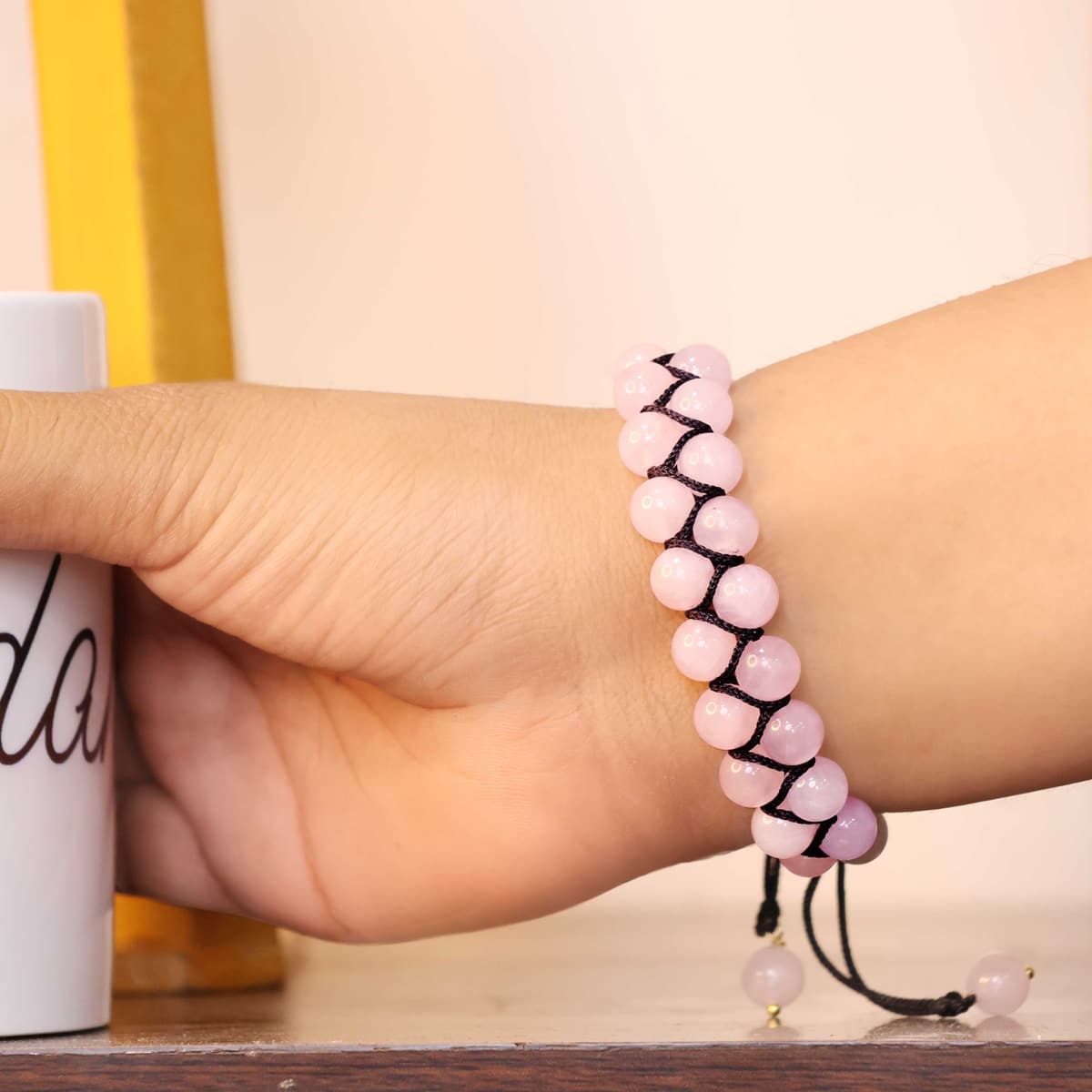 A beautiful Rose Quartz Adjustable Thread Bracelet featuring 8 mm round beads, showcasing its soft pink color and adjustable thread design.