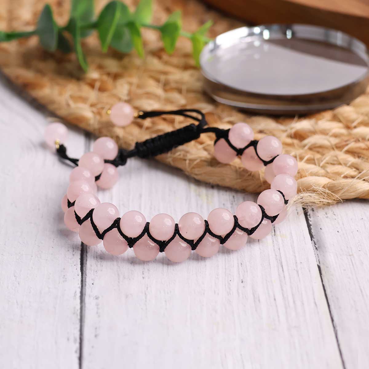 A beautiful Rose Quartz Adjustable Thread Bracelet featuring 8 mm round beads, showcasing its soft pink color and adjustable thread design.