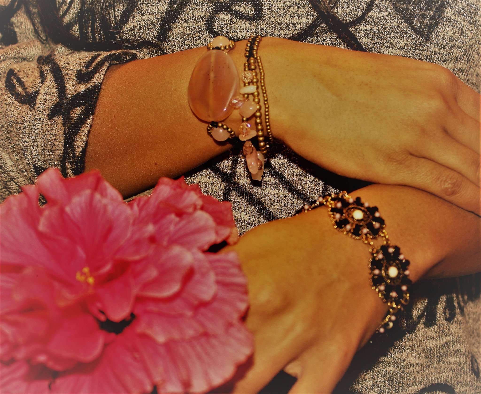 Rose Quartz & Crystals Romance Bracelet featuring soft pink crystals and brass bell drops on a black chord.