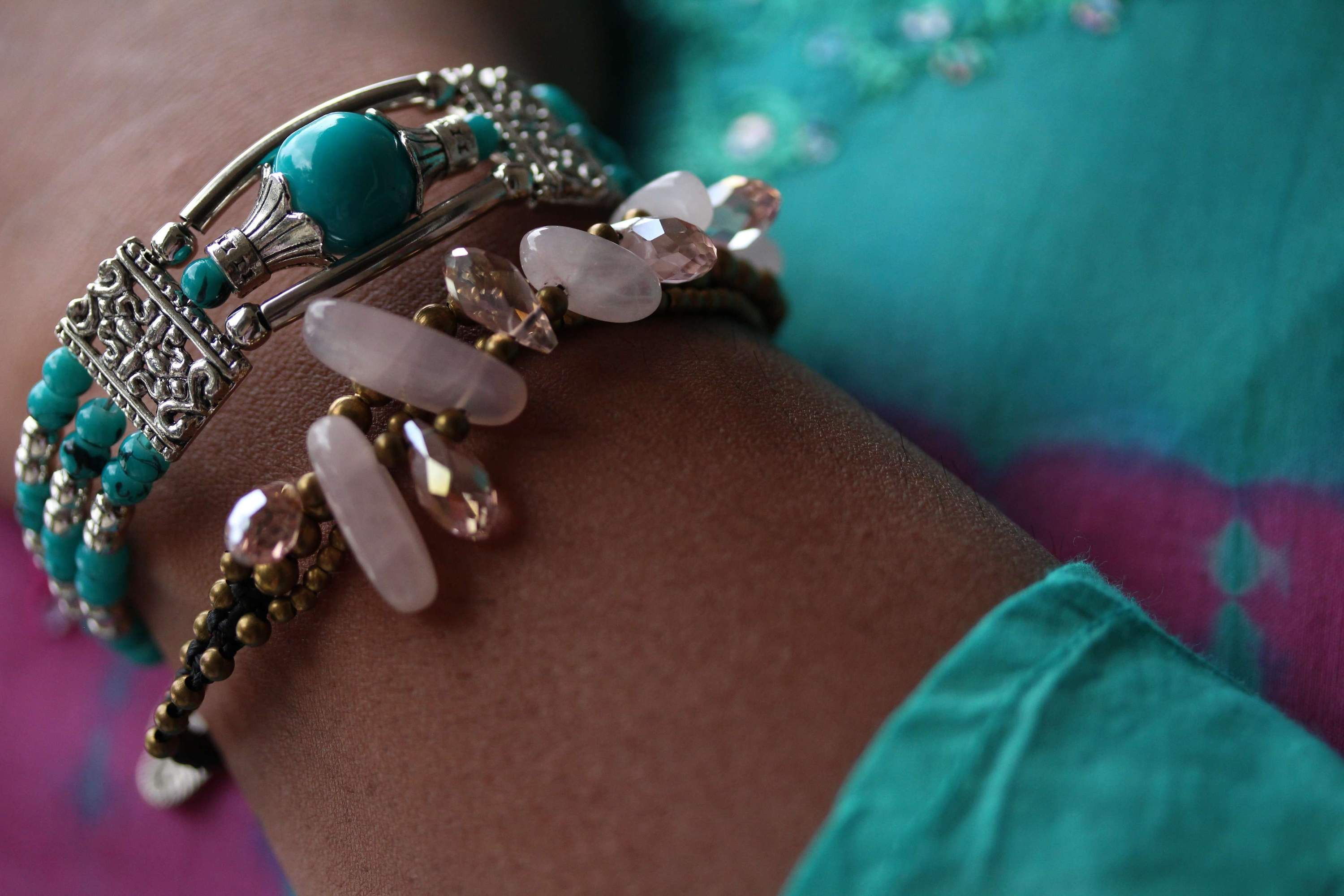 Rose Quartz & Crystals Romance Bracelet featuring soft pink crystals and brass bell drops on a black chord.