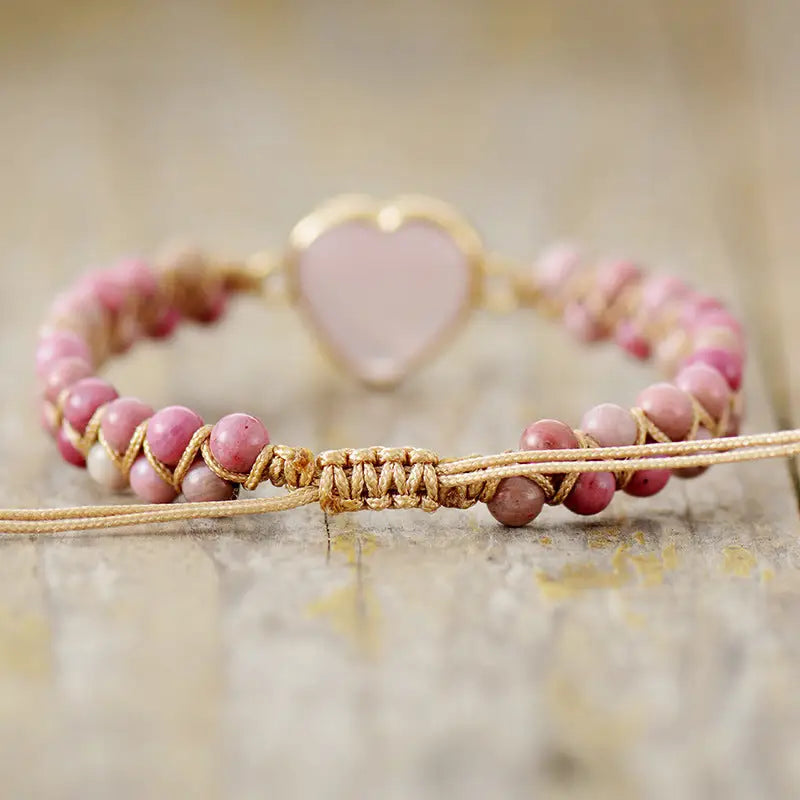 A delicate Rose Quartz Heart Charm Bracelet featuring genuine gemstones in a heart-shaped design, perfect for love and healing.