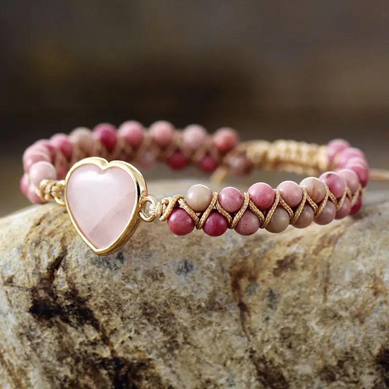 A delicate Rose Quartz Heart Charm Bracelet featuring genuine gemstones in a heart-shaped design, perfect for love and healing.