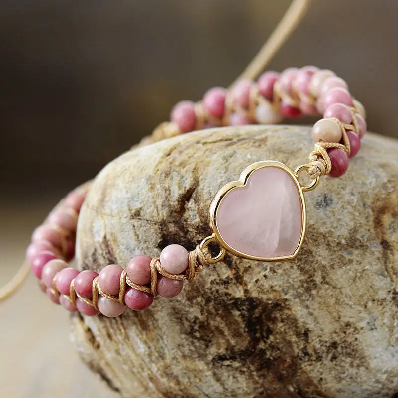 A delicate Rose Quartz Heart Charm Bracelet featuring genuine gemstones in a heart-shaped design, perfect for love and healing.