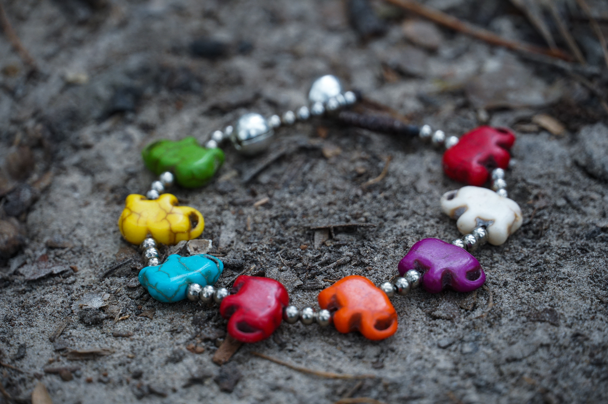 A handmade Silver Elephant Stone Bracelet featuring elegant elephant silver, colorful stones, and a durable cotton cord, perfect for boho style.