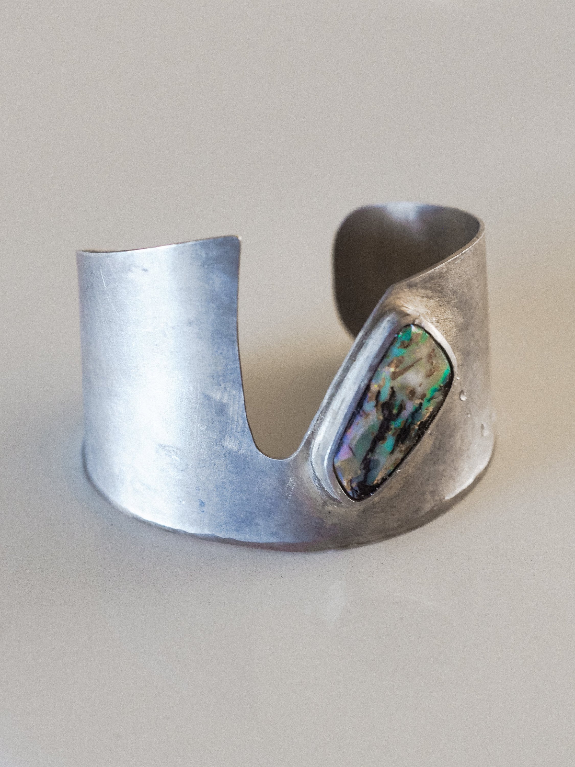 A stunning handmade cuff featuring turquoise and purple Boulder Opal set in high-quality Indian sterling silver.