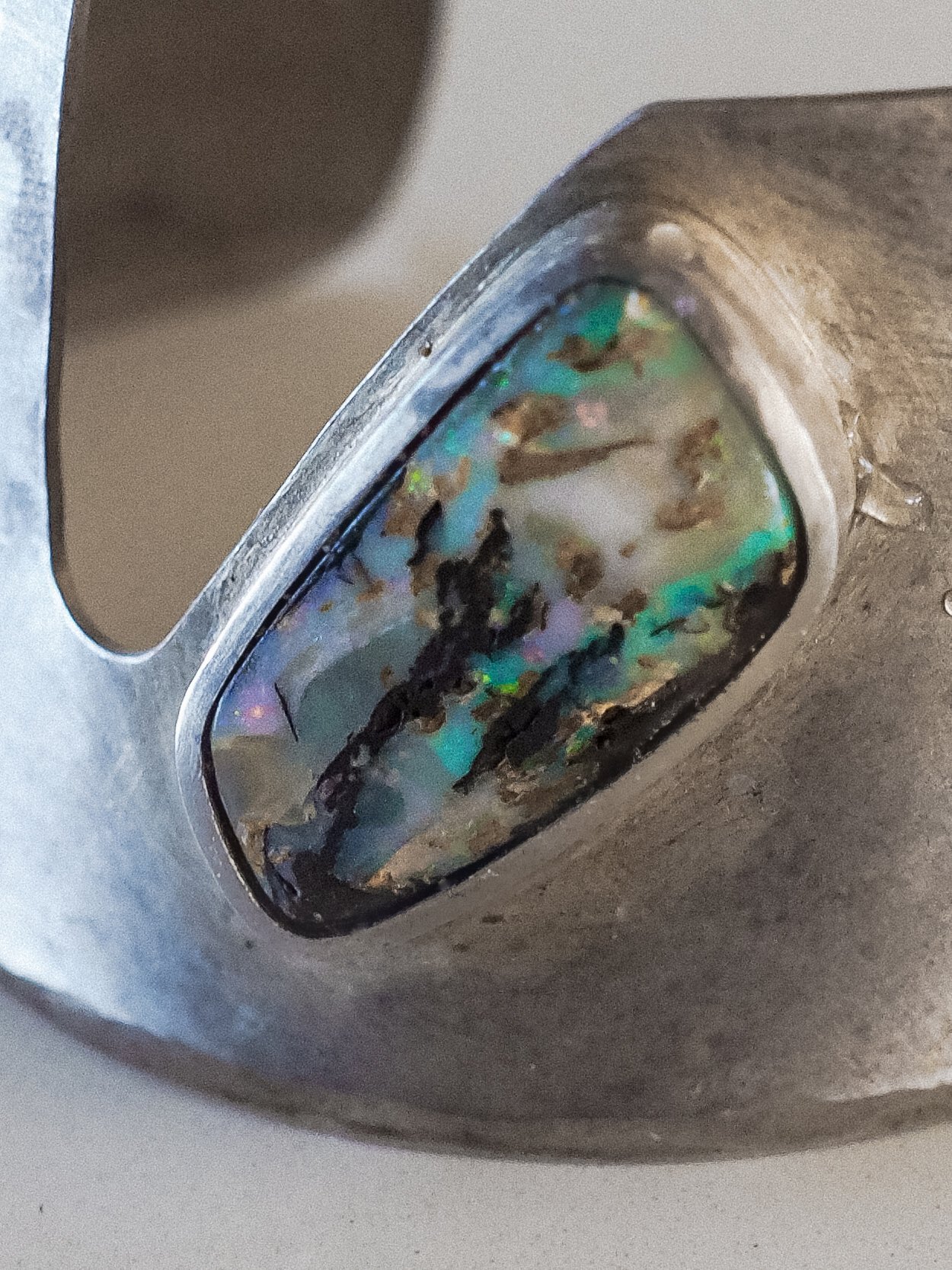 A stunning handmade cuff featuring turquoise and purple Boulder Opal set in high-quality Indian sterling silver.