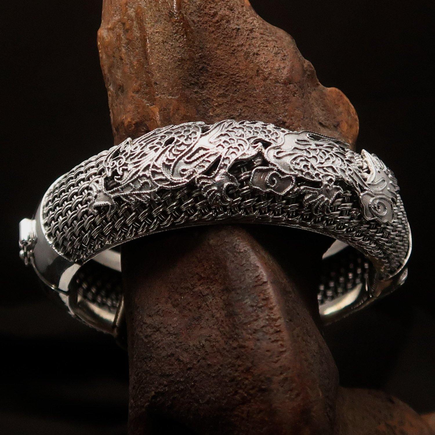 A stunning handcrafted sterling silver bracelet featuring an intricate dragon design, showcasing its quality and craftsmanship.