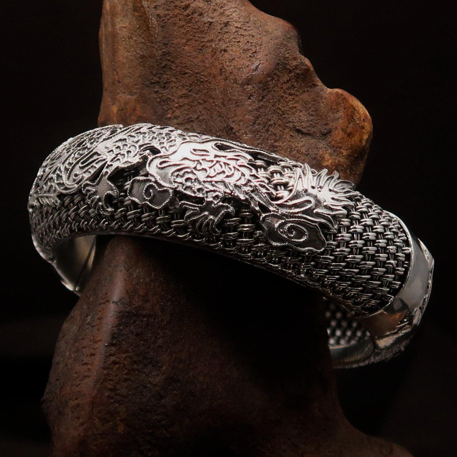 A stunning handcrafted sterling silver bracelet featuring an intricate dragon design, showcasing its quality and craftsmanship.