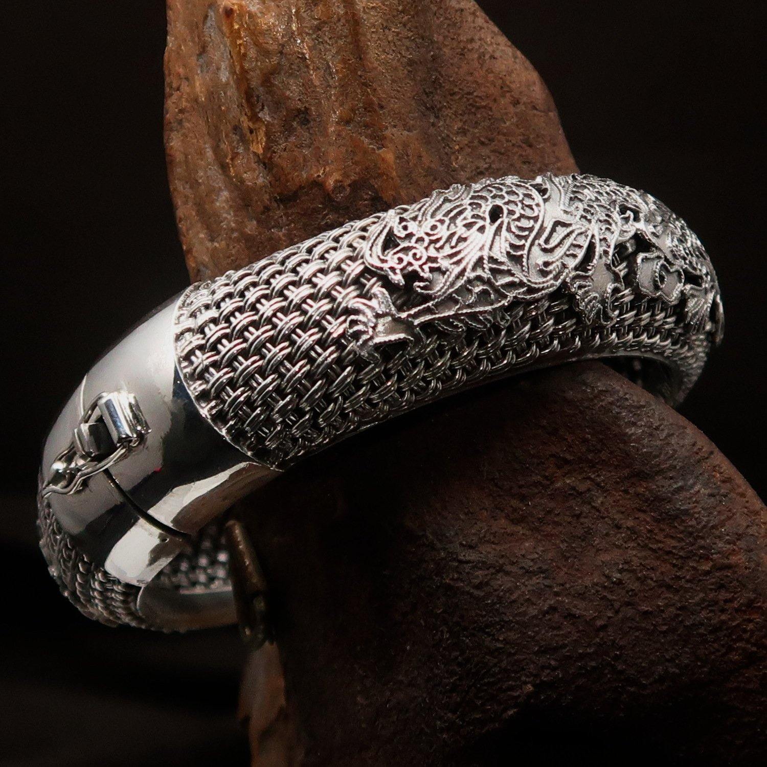 A stunning handcrafted sterling silver bracelet featuring an intricate dragon design, showcasing its quality and craftsmanship.