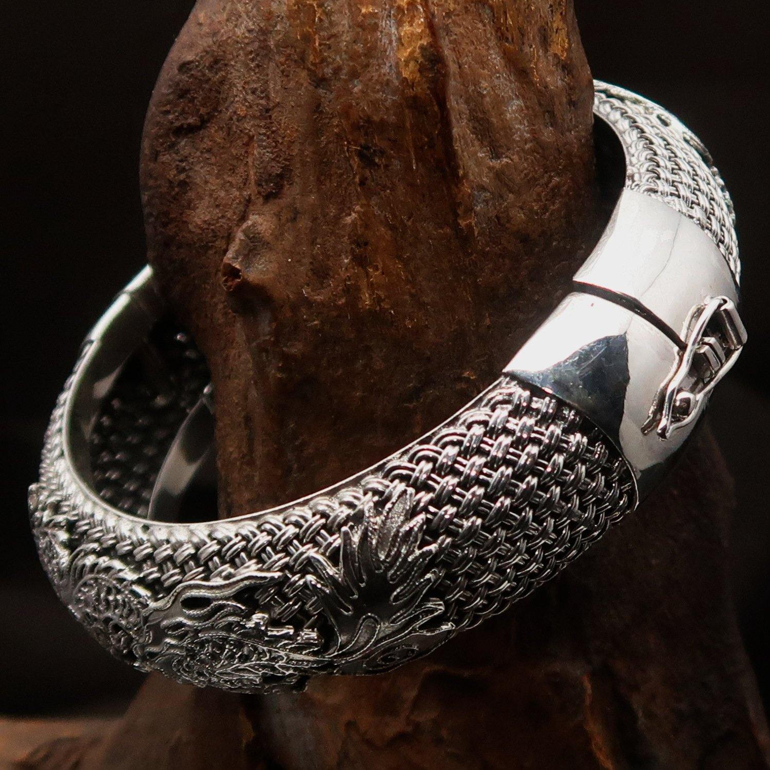 A stunning handcrafted sterling silver bracelet featuring an intricate dragon design, showcasing its quality and craftsmanship.