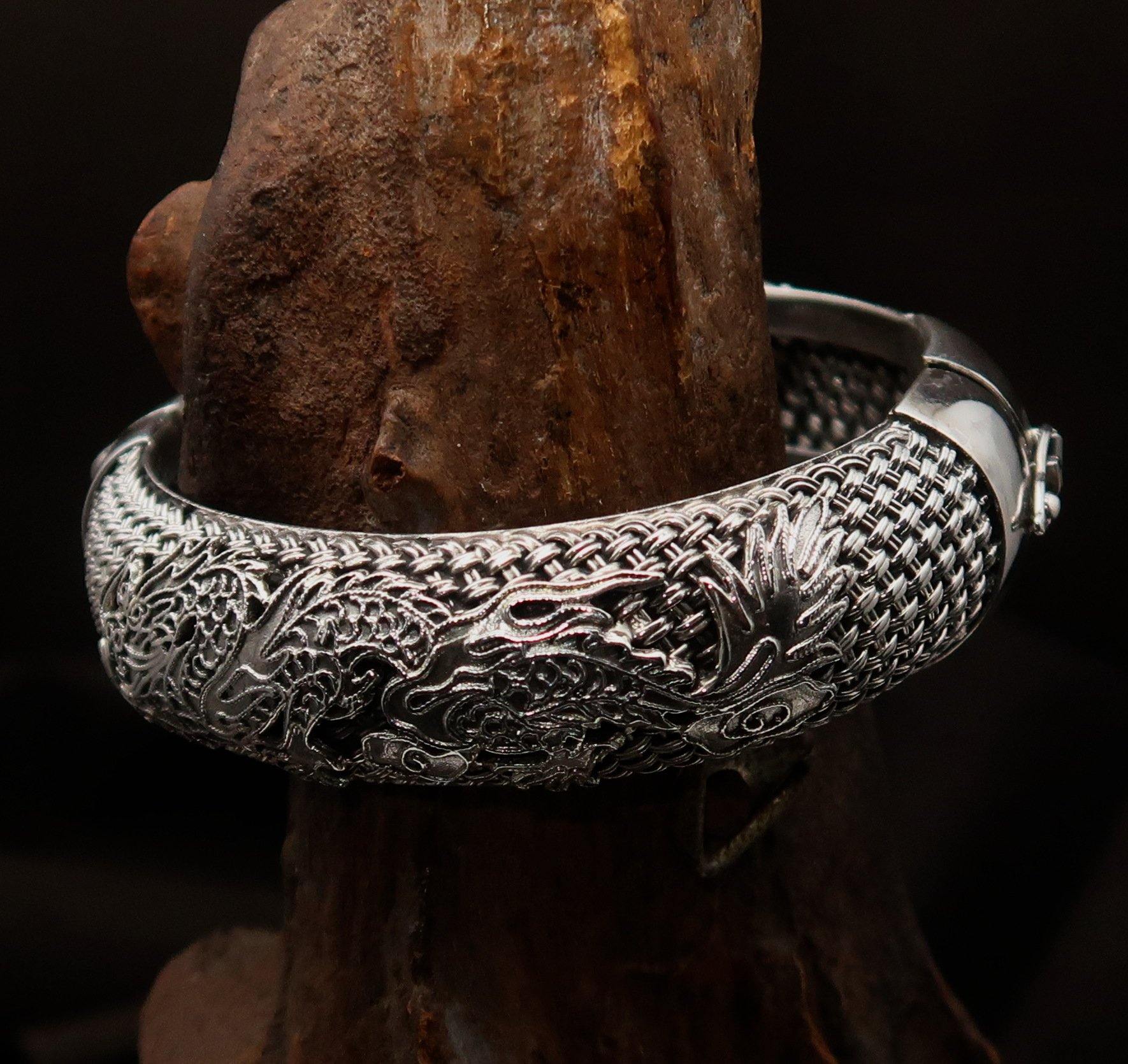 A stunning handcrafted sterling silver bracelet featuring an intricate dragon design, showcasing its quality and craftsmanship.