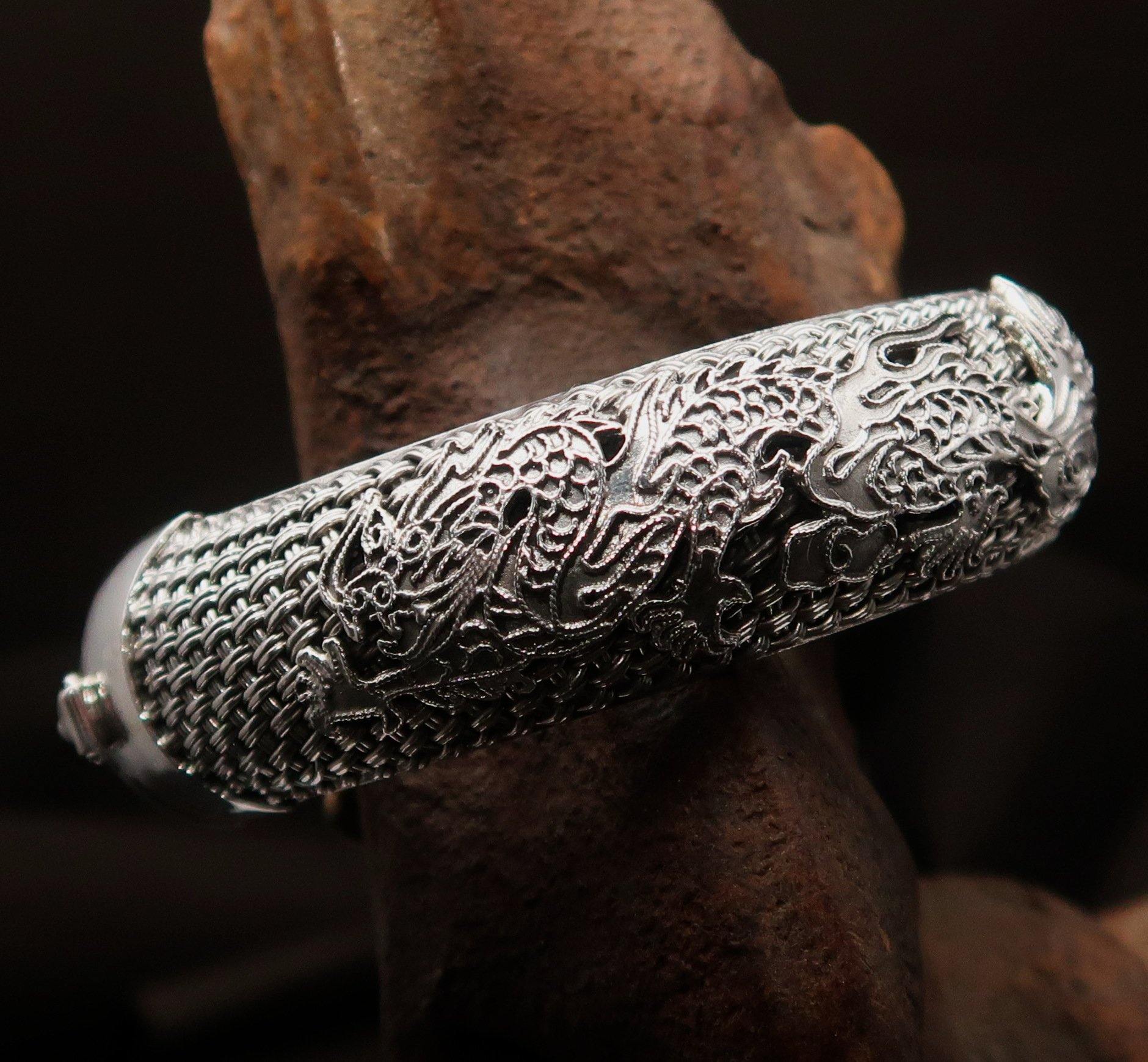 A stunning handcrafted sterling silver bracelet featuring an intricate dragon design, showcasing its quality and craftsmanship.