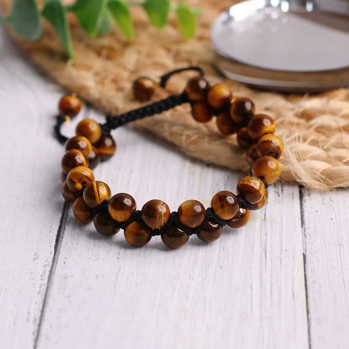 Adjustable Tiger Eye bracelet featuring natural round beads in golden-brown hues, symbolizing protection and courage.