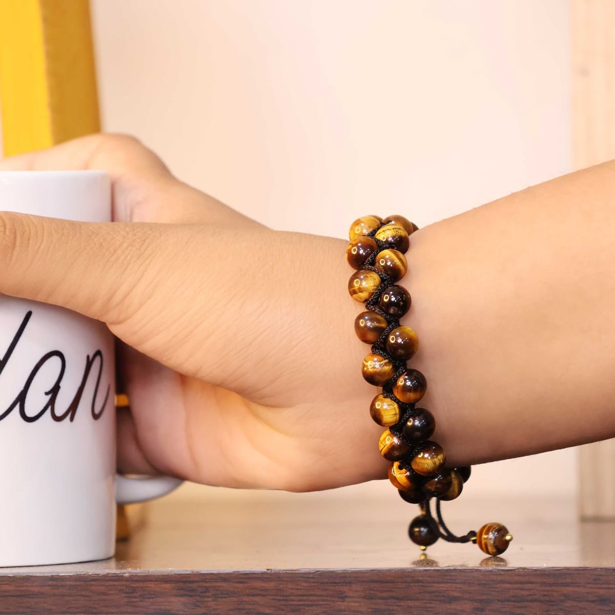 Adjustable Tiger Eye bracelet featuring natural round beads in golden-brown hues, symbolizing protection and courage.