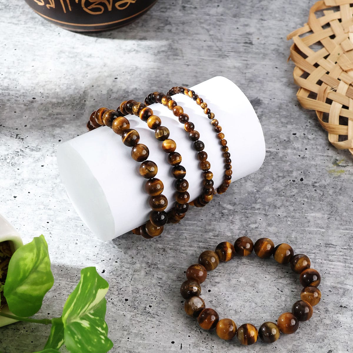 A close-up view of a Tiger Eye Round Beads Bracelet showcasing its natural golden-brown hues and round beads, elegantly strung on elastic.