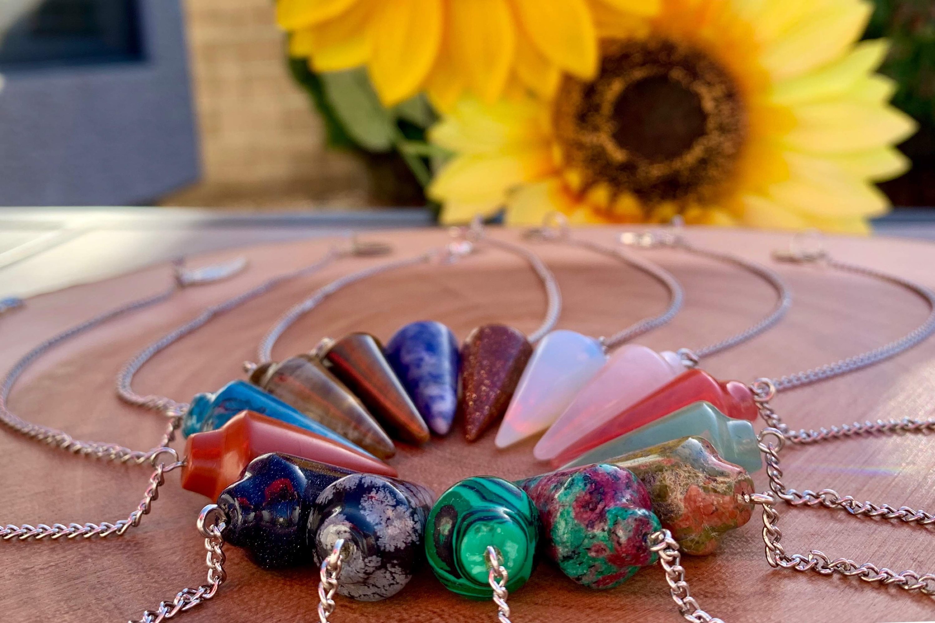 Tigers Eye Dowsing Pendulum and Bracelet showcasing golden yellow and deep yellow-brown hues with black stripes, symbolizing strength and grounding.