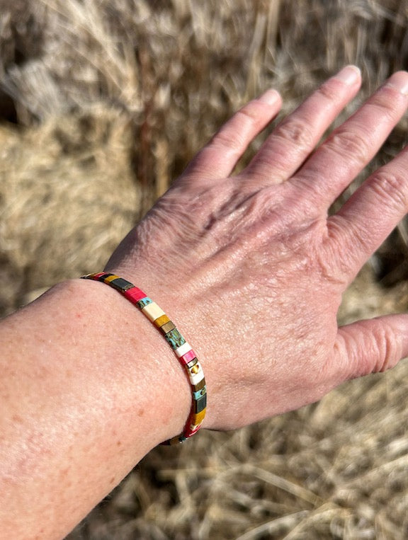 Tila Set Beach Bum white stretchy beaded bracelet featuring vibrant colors like turquoise, sandy tan, and pink, perfect for summer styling.